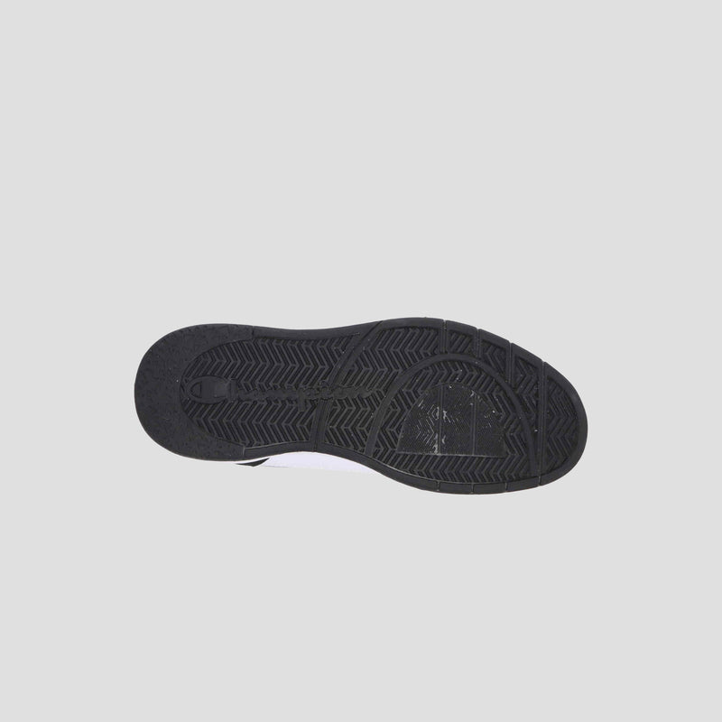 The image shows the black rubber outsole of the Champion Women's 5-on-5 Low sneaker against a light gray background, featuring textured tread patterns for grip and traction with a sleek, minimalist design.