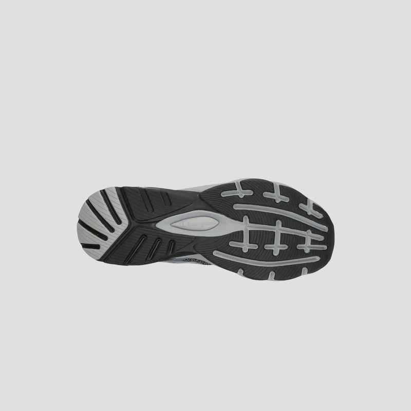 The image shows the bottom view of a black and gray Champion Men's Alpha athletic shoe sole, featuring a textured tread for grip and support—perfect for gym workouts or everyday men's sneakers.