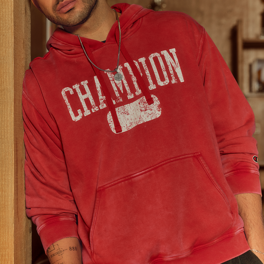 Person wearing a red Champion hoodie indoors