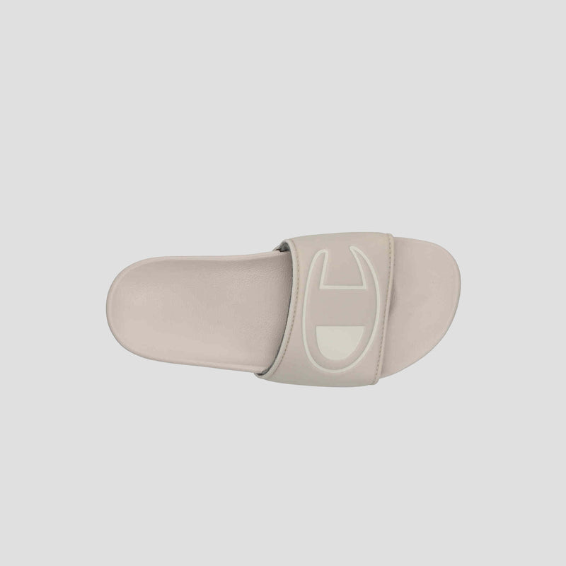 A top view of the Champion Women's IPO Slide shows its wide strap with raised geometric design and contoured footbed, set against a plain light grey background, emphasizing lightweight comfort.