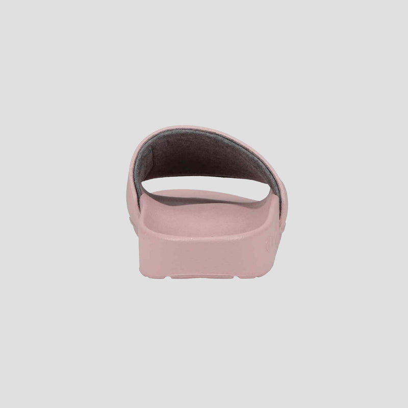 A rear view of the Champion Women's IPO Slide in light pink shows its open back, single thick top strap, and contoured footbed, all set against a plain light gray background.