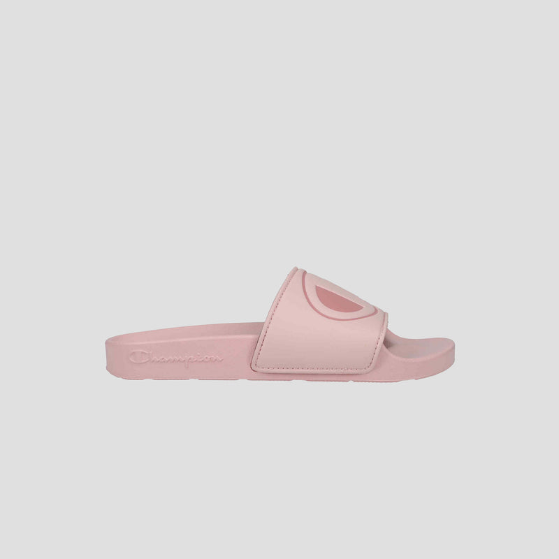 The Champion Women's IPO Slide features a light pink color, contoured footbed, and wide strap with the brand's logo in darker pink, shown in side profile on a plain white background.