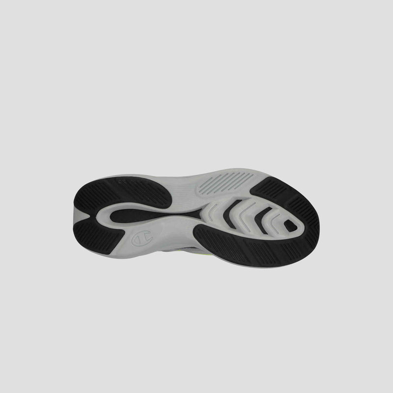 The image shows the sole of the Champion Men's Acceleron sneaker, with a gray base, black rubber traction patterns and grooves for grip, plus a stylized C logo near the heel that highlights its running shoe design.