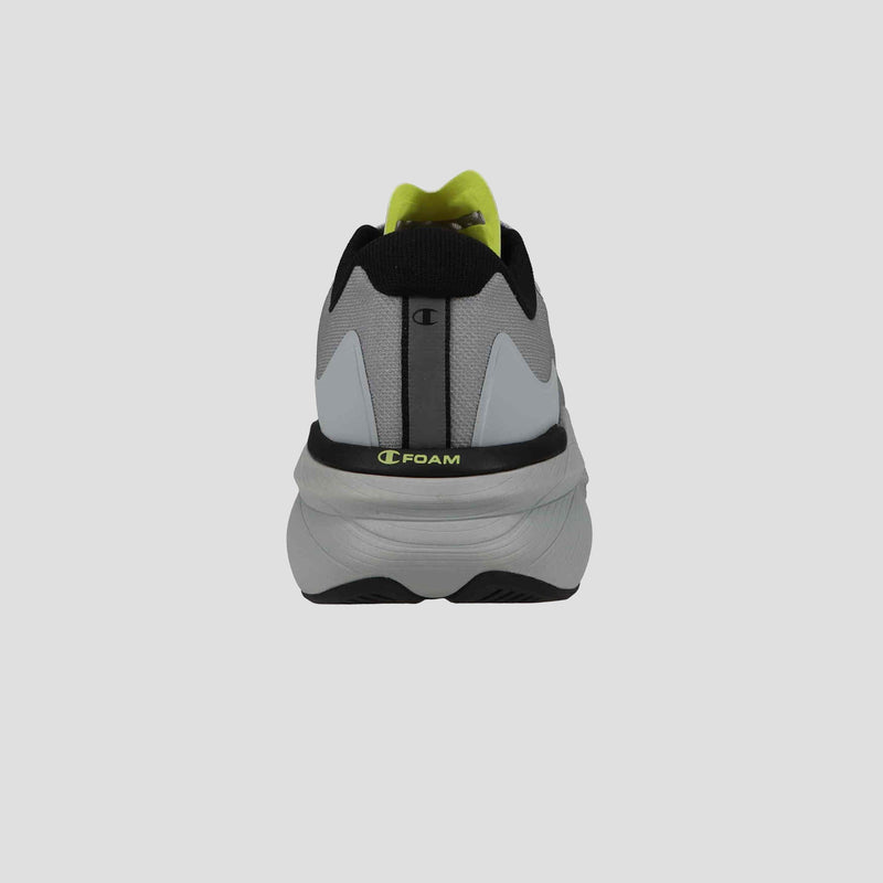 A gray Champion Men's Acceleron sneaker is shown from the back with black accents, a thick white foam sole, neon yellow inner lining, and a small Champion logo above the heel—a stylish choice for runners.