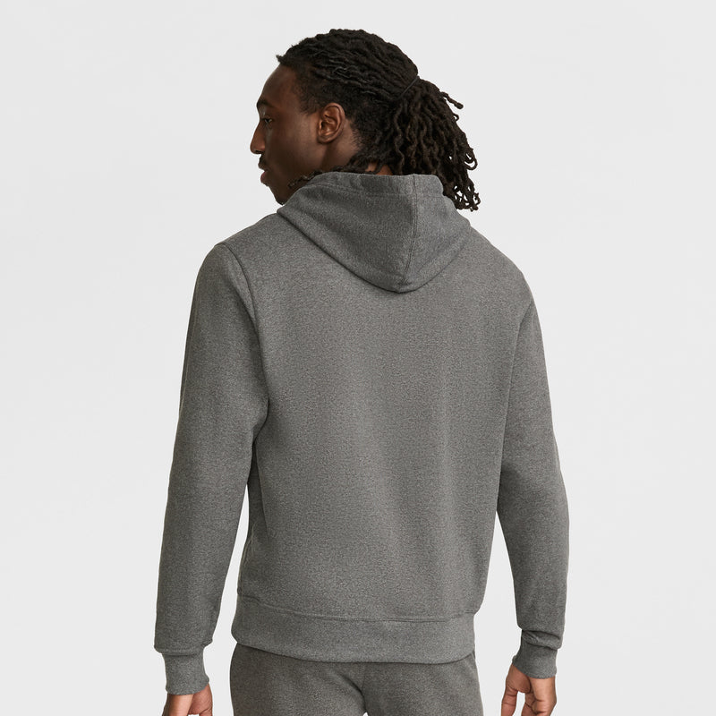 A person with long, dark, curly hair is seen from behind wearing a gray Champion Powerblend Hoodie, Full Script Logo, against a plain white background.