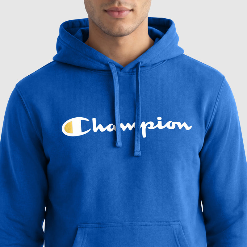 A person wears the Champion Powerblend Hoodie, Full Script Logo—a bright blue men’s fleece with "Champion" in white and yellow on the chest—shown from the shoulders up against a plain light gray background.