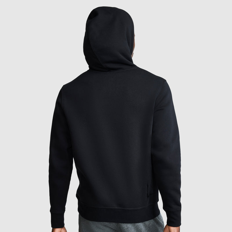 A person is shown from the back against a plain gray background, wearing the Champion Powerblend Hoodie with the hood up. This men's hoodie in black features a tonal script logo and blends modern style with cozy comfort.