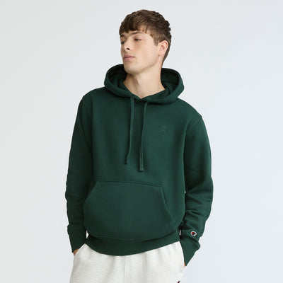 Person wearing a green hoodie on a white background