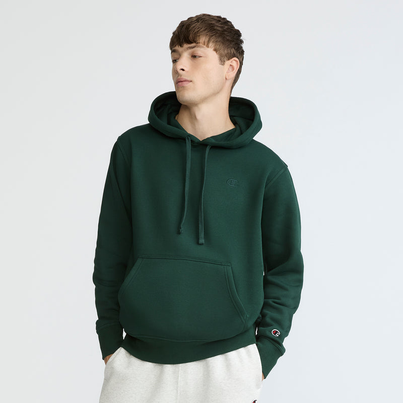 Person wearing a green hoodie on a white background