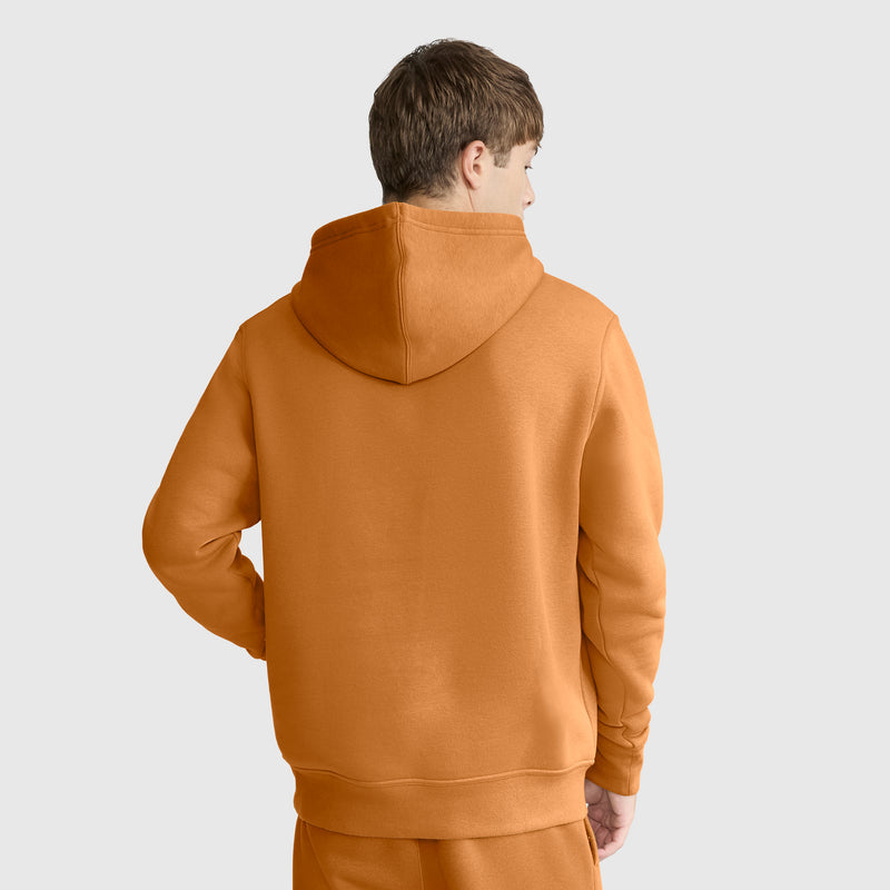 Wearing a Champion Powerblend Hoodie, C Logo, and matching pants, a person stands with their back to the camera against a light gray background.