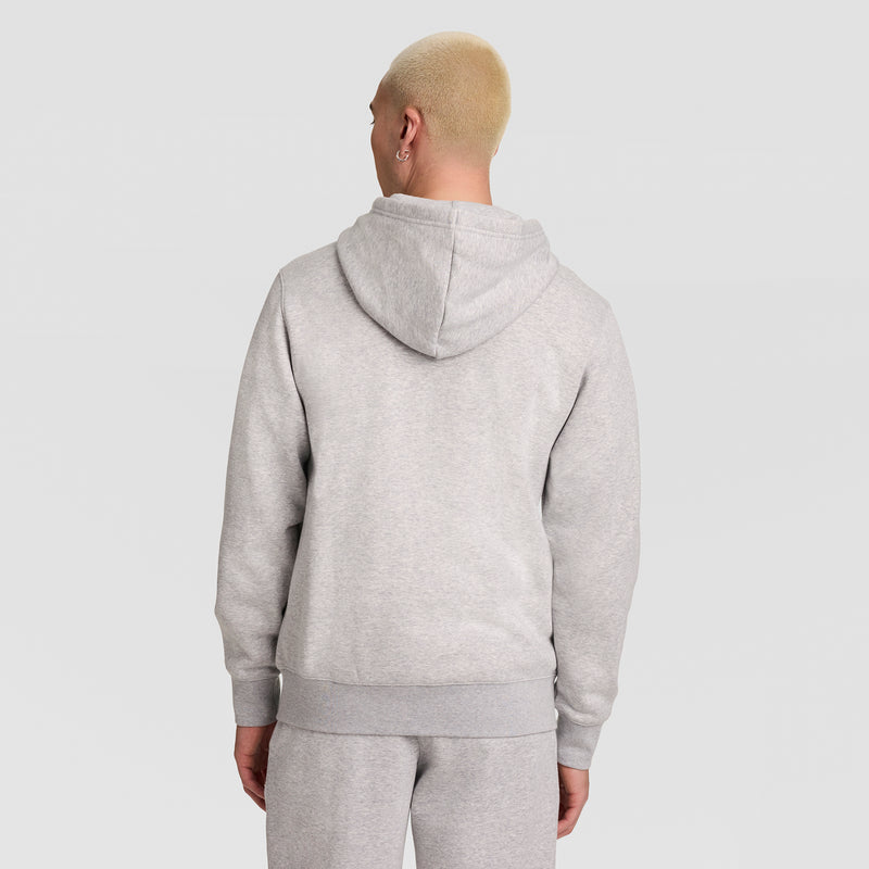 A person with short blond hair is seen from behind, wearing a Champion Powerblend Full-Zip Hoodie with C Logo and matching light gray sweatpants, standing against a plain light background.