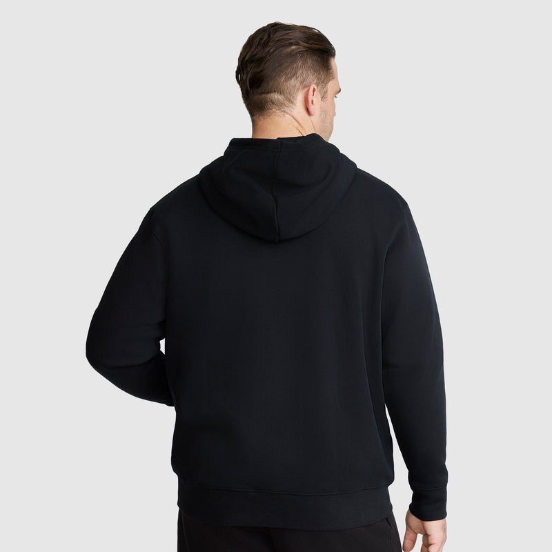 A man is standing with his back to the camera, wearing the Champion Powerblend Full-Zip Hoodie, C Logo - Big & Tall, against a plain light gray background.