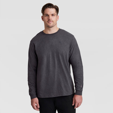 A man wearing a Champion Classic Long Sleeve T-Shirt with Embroidered C Logo – Big & Tall and black pants stands against a plain light gray background, looking forward with a neutral expression.