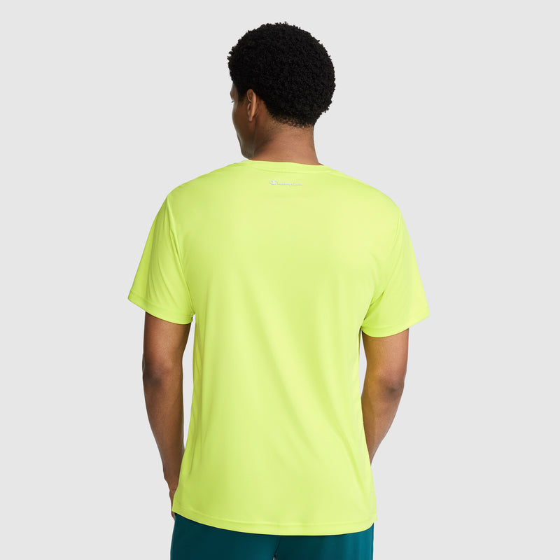 A person is shown from the back against a plain light gray background, wearing the Champion Sport T-Shirt with a reflective C logo. This bright yellow men’s athletic shirt features moisture-wicking fabric and a small white reflective Champion logo near the neckline.
