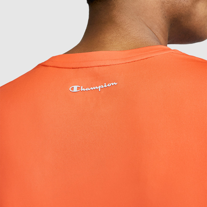 Close-up of a person wearing the orange Champion Sport T-Shirt with Reflective C Logo, showing only the back and part of their neck. The brand name “Champion” is printed in white near the collar.