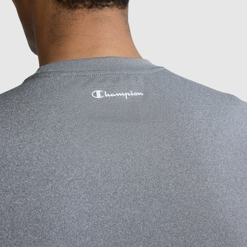 Close-up of a person’s upper back and neck wearing a gray Champion Sport Muscle Tank, Reflective C Logo. The men's sleeveless workout shirt features the signature Champion reflective “C” logo near the collar and is crafted from moisture-wicking fabric for comfort during intense workouts.