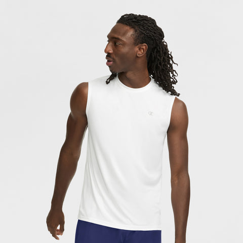 A man with long braided hair wears the Champion Sport Muscle Tank with Reflective C Logo and blue shorts, looking to his left against a plain white background.