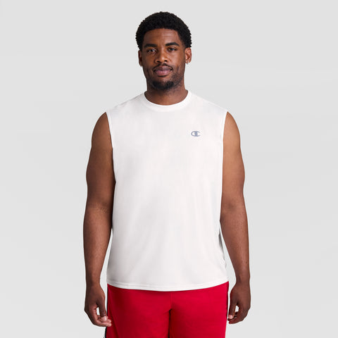 A man wears the Champion Sport Muscle Tank, Reflective C Logo - Big & Tall, in white, paired with red shorts. He stands facing forward against a light gray background, highlighting this moisture-wicking men’s workout shirt.