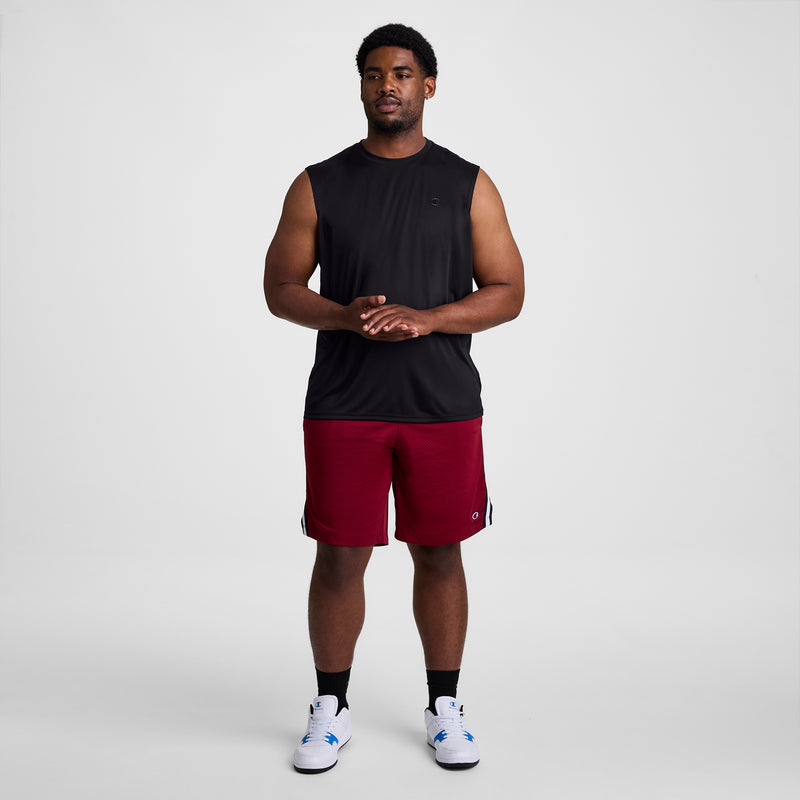 A man stands facing forward in a Champion Sport Muscle Tank with Reflective C Logo - Big & Tall, paired with red athletic shorts, white socks, and white sneakers against a plain white background.