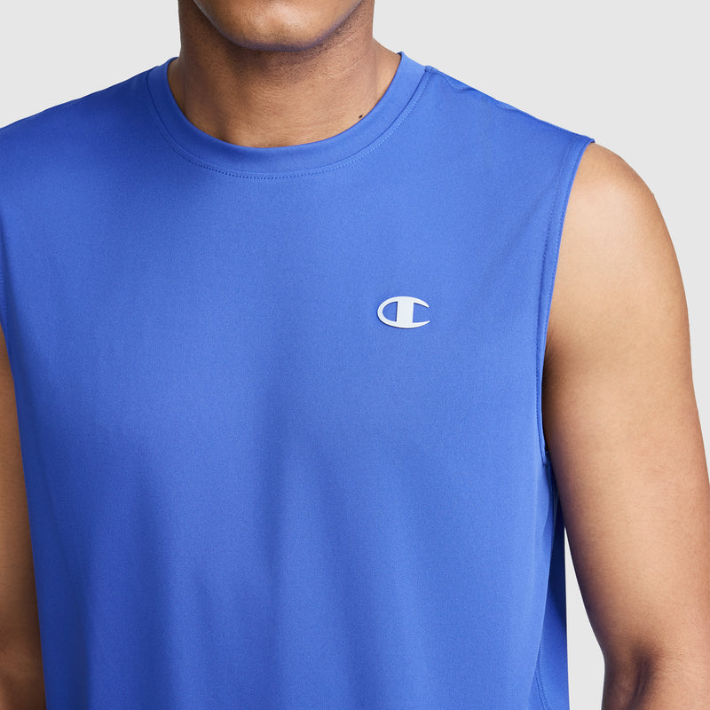 A person wearing the Champion Sport Muscle Tank, Reflective C Logo—a sleeveless blue athletic top with a small Champion logo on the chest—shown from the shoulders to mid-torso. This men's tank features moisture-wicking fabric for added comfort during workouts.