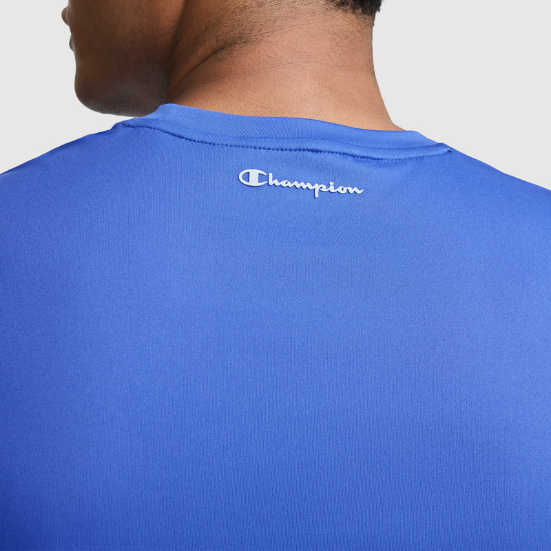 A close-up of the back of a person wearing a blue Champion Sport Muscle Tank, Reflective C Logo. This sleeveless men's workout shirt features the white reflective Champion logo near the collar and is crafted with moisture-wicking fabric to help keep you cool and comfortable during your workout.
