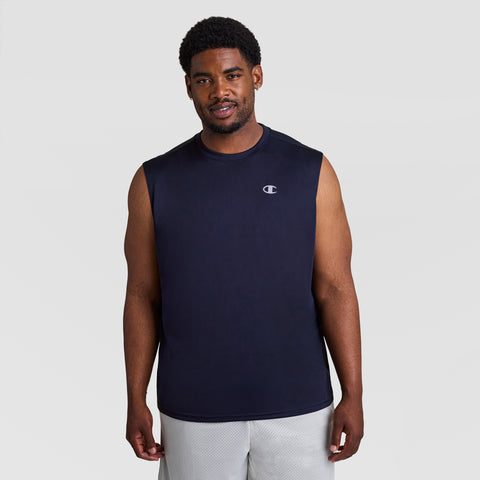 A man wearing the Champion Sport Muscle Tank, Reflective C Logo - Big & Tall in navy blue and light gray shorts stands facing the camera against a plain light gray background.