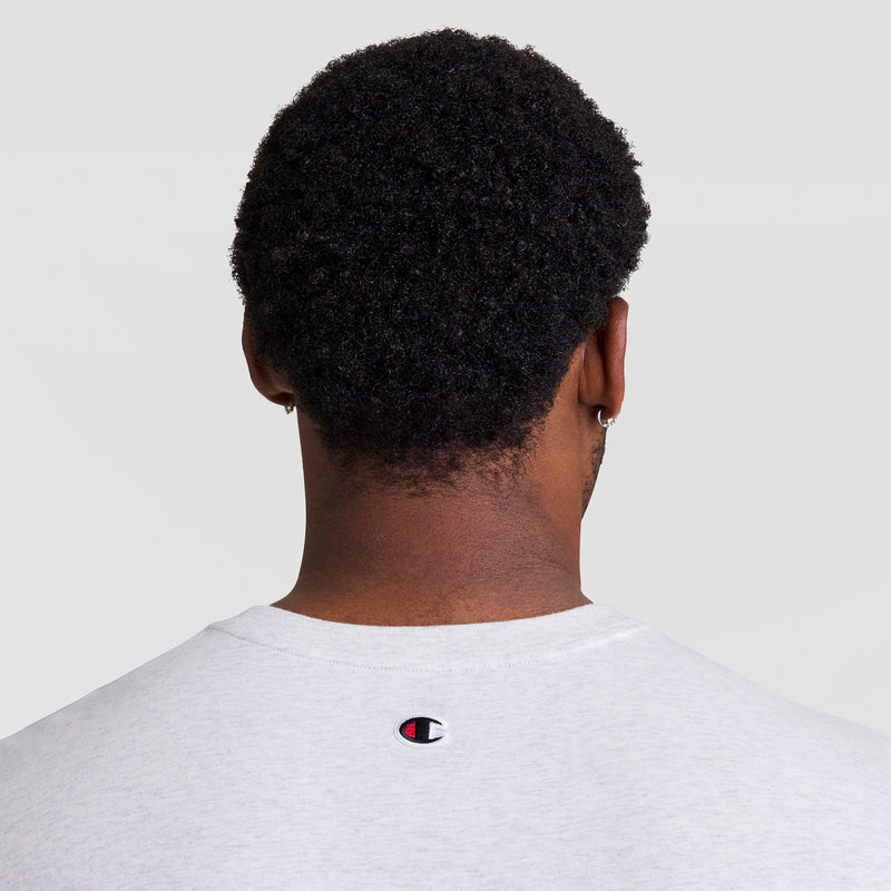 A person with short, curly dark hair is seen from behind wearing a light gray Champion Muscle Tank, C Logo - Big & Tall, featuring a small logo on the upper back against a plain light background.