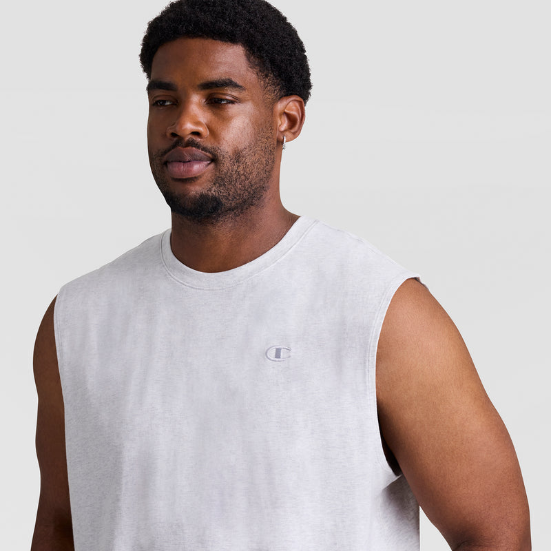 A man with dark skin and curly hair wears the Champion Muscle Tank, C Logo - Big & Tall in light gray, featuring a small chest logo. He has a light beard and a hoop earring.
