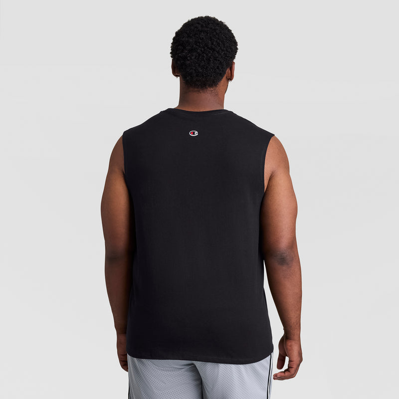 A man stands with his back to the camera, wearing a black Champion Muscle Tank, C Logo - Big & Tall, and light gray athletic shorts against a plain light background.