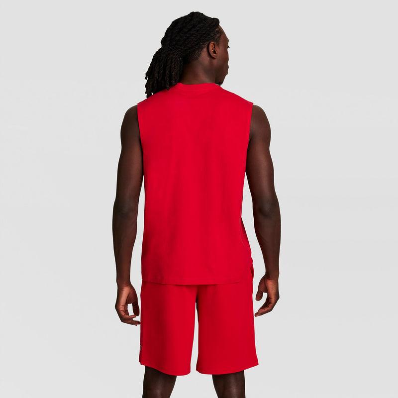 A person with long, dark hair faces away from the camera, wearing a Champion Muscle Tank with C Logo and matching red shorts, set against a light gray background.