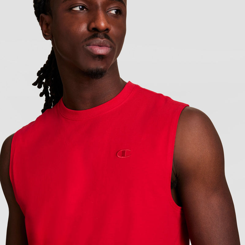 A person wearing the Champion Muscle Tank with a small C logo on the chest looks to the side against a plain light background.