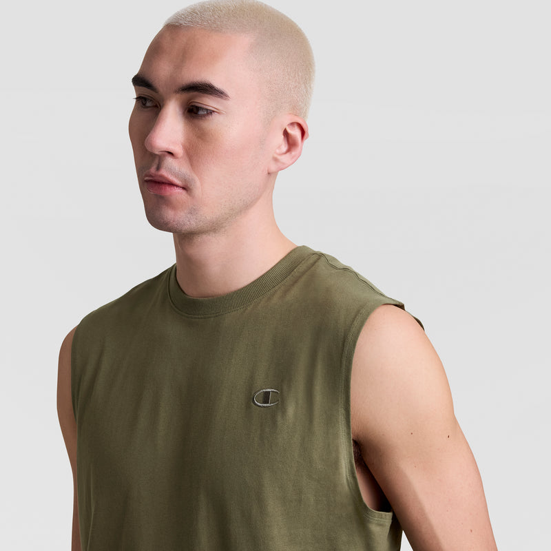 A person with short, bleached blond hair models the Champion Muscle Tank, C Logo—an olive green muscle tee with a small embroidered chest logo—against a plain light gray backdrop.