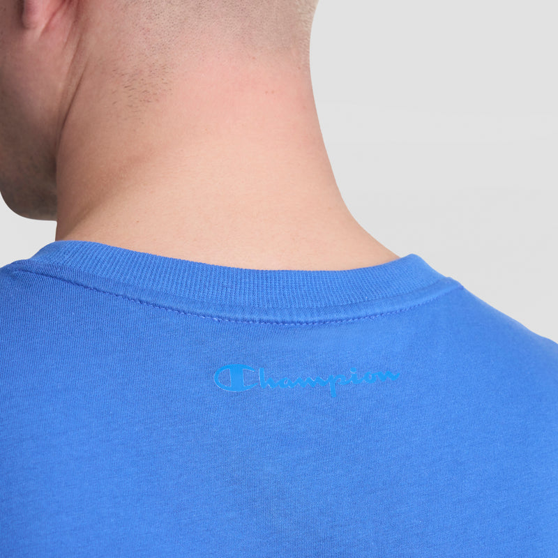 The image shows the back of a person wearing a bright blue Champion Muscle Tank, C Logo. "Champion" is printed in light blue near the upper back collar.