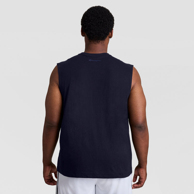 A man with short curly hair is seen from behind, wearing a black Champion Muscle Tank, C Logo - Big & Tall, and white shorts against a plain light gray background.