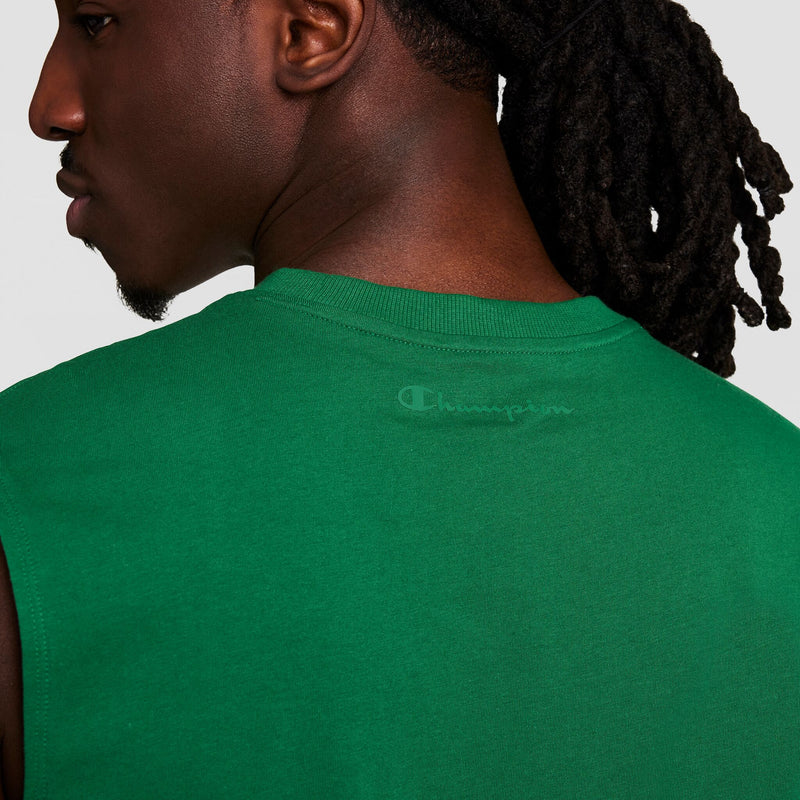 A person with long, dark braids is shown from behind and in profile, wearing a sleeveless green Champion Muscle Tank featuring a faint C Logo on the upper back.