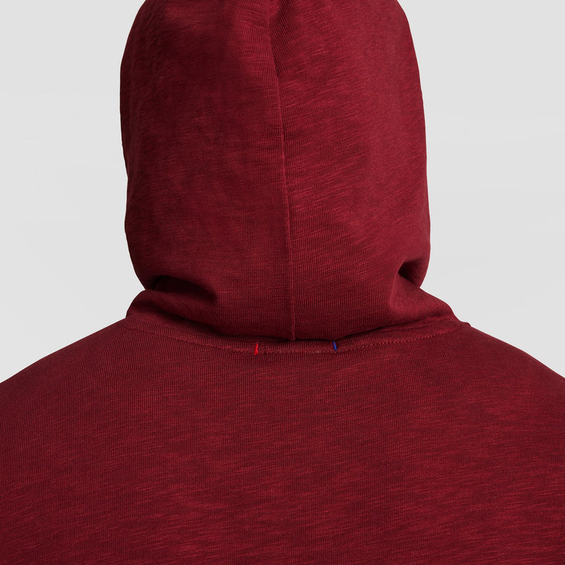 A person is shown from behind wearing the Champion Modern Retro Washed Hoodie with C Logo, hood up, covering head and neck. The background is plain light gray.