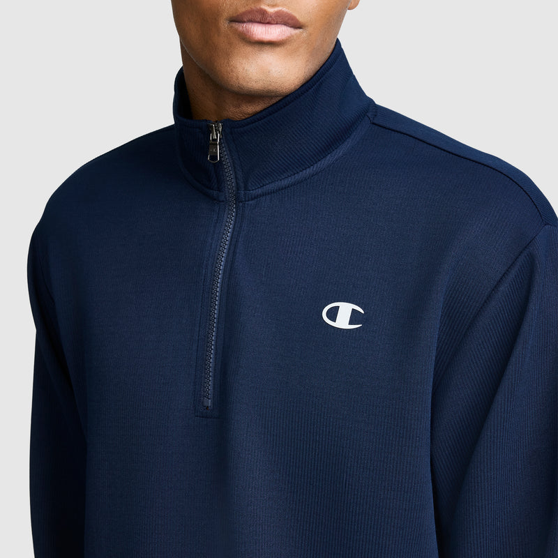 A person wears the Champion Sport Long Sleeve 1/4 Zip Mockneck, featuring a small white C logo on the left chest, set against a plain light background.