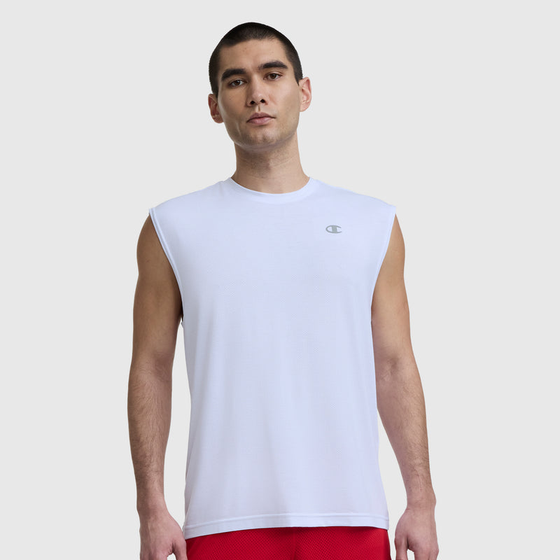 A man in a Champion Sport Crewneck Muscle Tee, Script Logo (white) and red shorts stands facing forward against a plain light background.