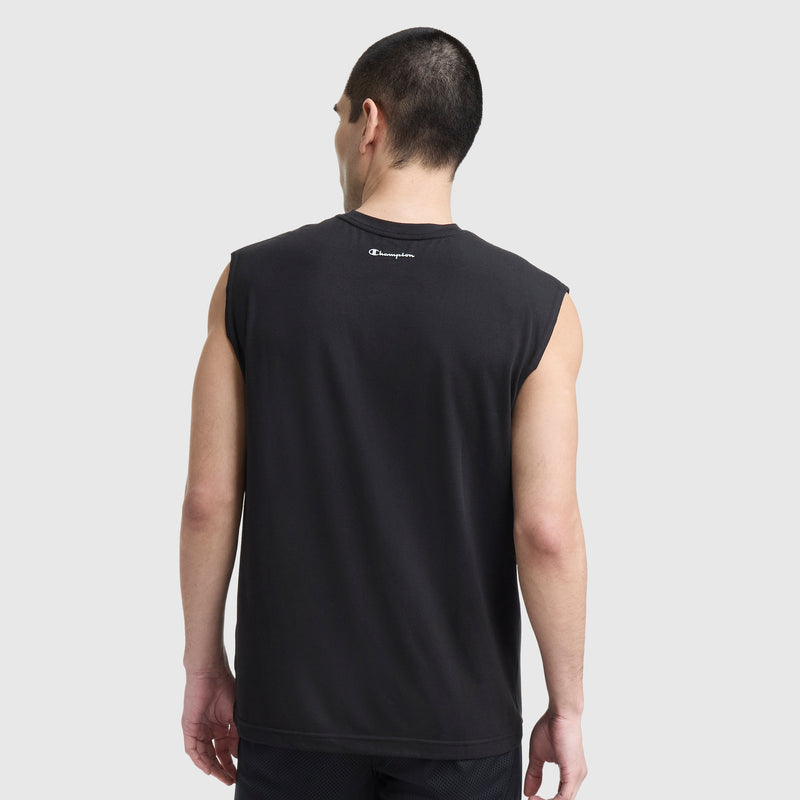 A man with short dark hair is seen from the back in a sleeveless black Champion Sport Crewneck Muscle Tee, Script Logo, and black shorts. The tee features a small Champion logo near the neckline against a plain light gray background.