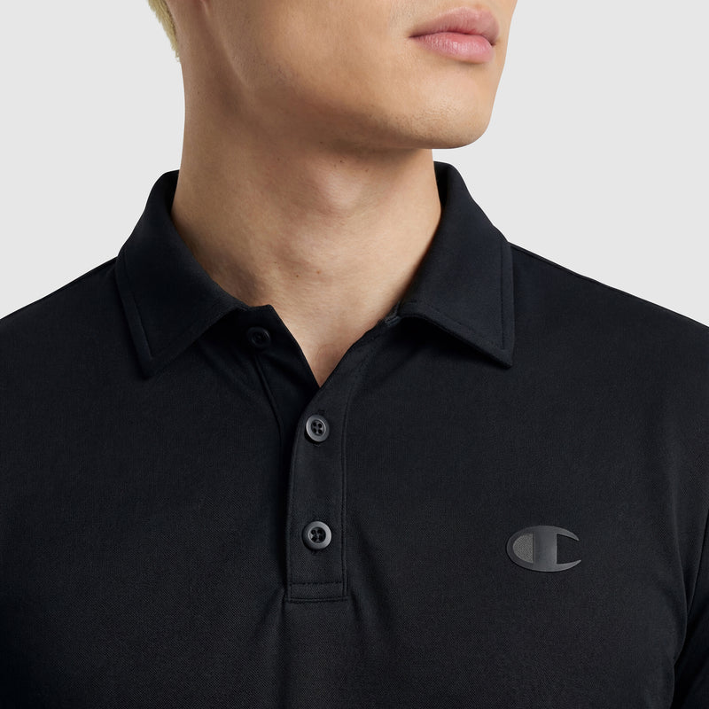 A person in a black Champion Sport Polo, featuring a three-button placket and C Logo on the left chest, is shown from shoulders up against a plain background, highlighting its athletic style.