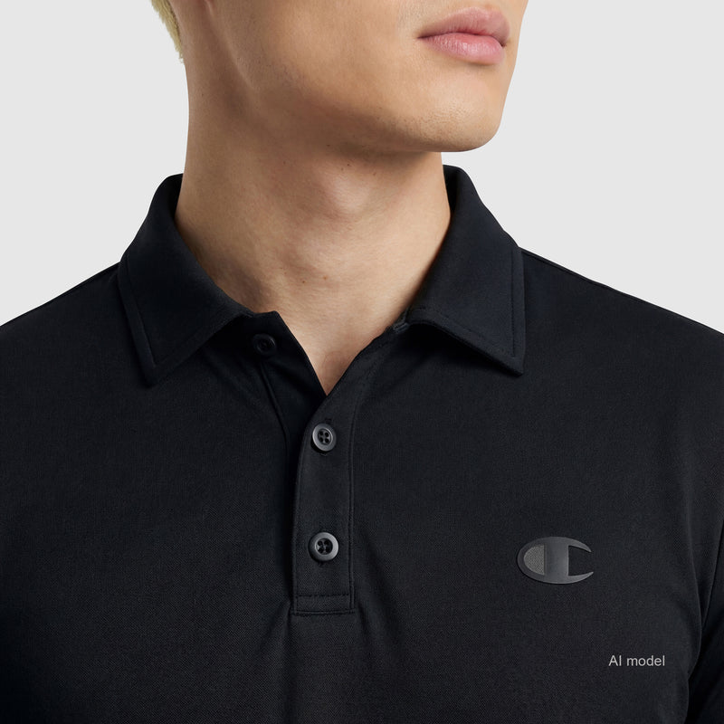 A person wearing the Champion Sport Polo with a C logo on the left chest, black color, three-button placket, and four-way stretch, posing slightly to the side against a plain light background.