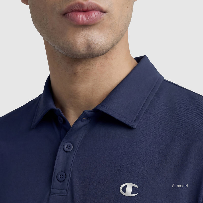 A person is wearing the Champion Sport Polo, C Logo—a navy blue tri-blend shirt with buttons and a small white logo on the chest. Only the lower part of their face is visible; their eyes are not shown.