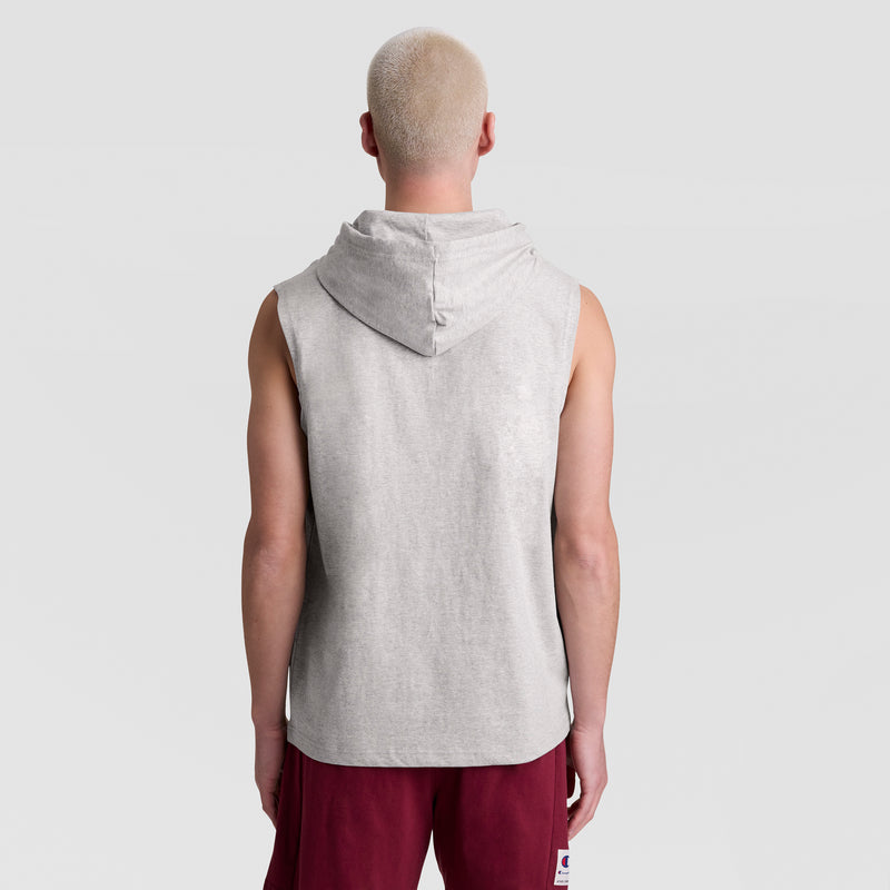A person with short, light blonde hair stands with their back to the camera, wearing a Champion Sleeveless Hoodie with an Embroidered C Logo and burgundy shorts against a plain light gray background.
