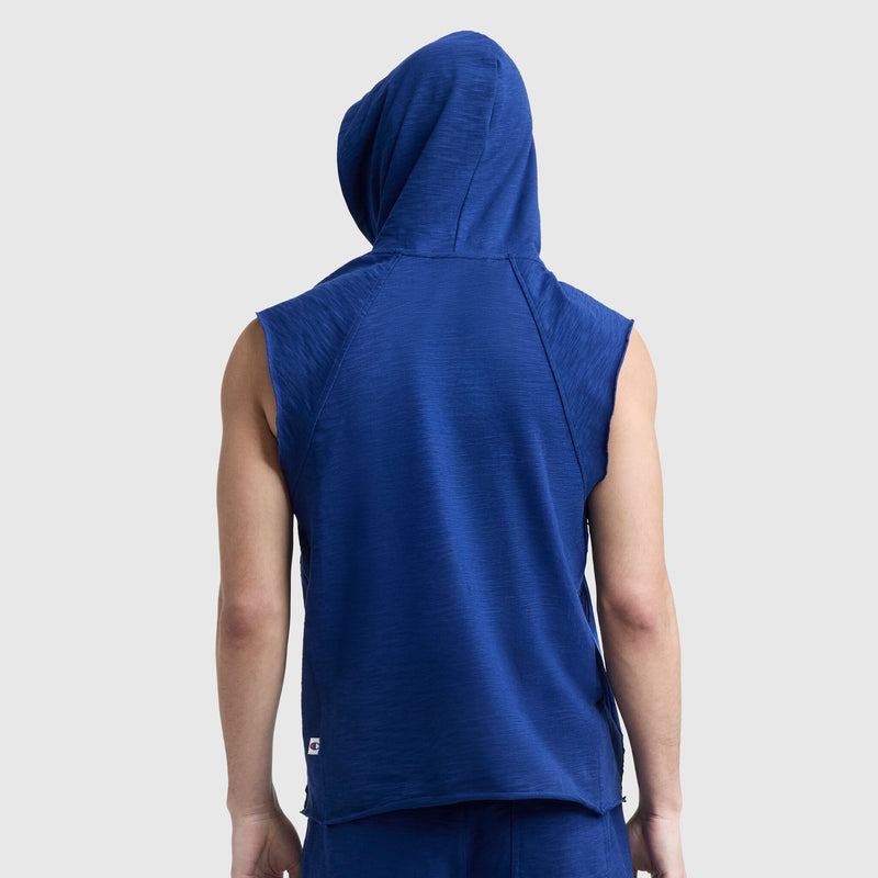 A person wearing the Champion Modern Retro Washed Sleeveless Hoodie with the C Logo, hood up, is seen from the back against a plain light gray background for a subtle vintage gym vibe.