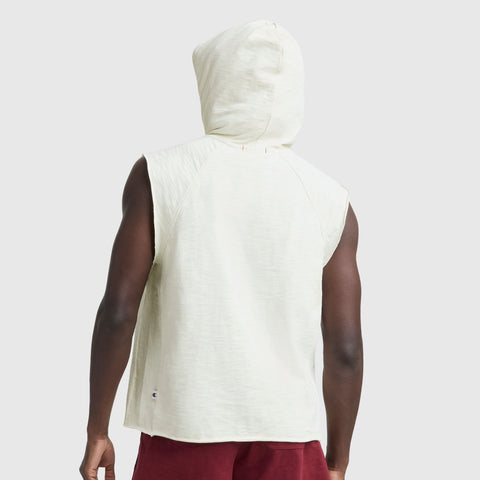 Back view of a man in vintage gym style, wearing a Champion Modern Retro Washed Sleeveless Hoodie with C Logo and burgundy shorts, set against a light grey background.