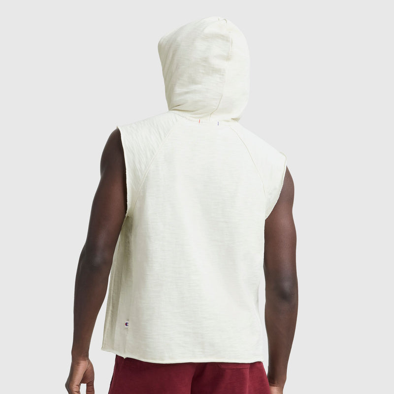 Back view of a man in vintage gym style, wearing a Champion Modern Retro Washed Sleeveless Hoodie with C Logo and burgundy shorts, set against a light grey background.
