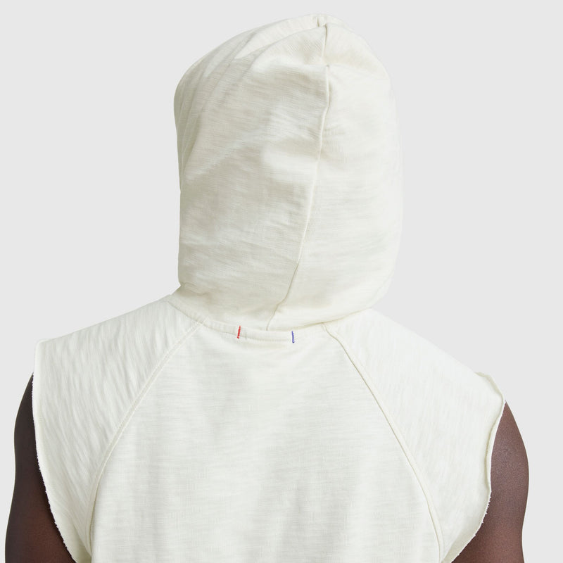 Someone wearing the Champion Modern Retro Washed Sleeveless Hoodie with the hood up, viewed from behind against a plain light gray background—showcasing the timeless style of this C Logo vintage-inspired gym hoodie.