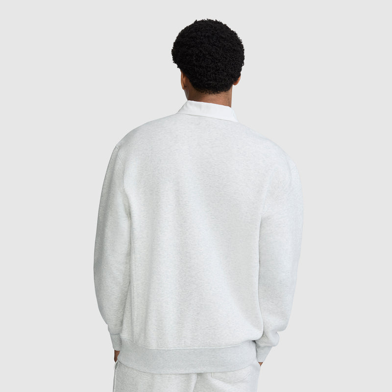 A person with short curly hair, seen from behind, is wearing the Champion Fleece Rugby and matching pants against a plain light background.