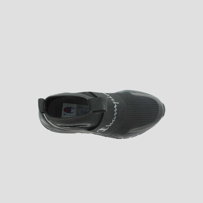 Top view of the Champion Kids' Rally Pro: a black slip-on athletic shoe with mesh details, elastic band across the midfoot, rounded toe, and Champion logo on both the insole and band. No visible laces for easy wear.