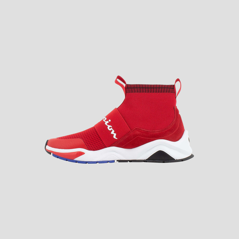 The Champion Men's Rally Pro sneaker features a red sock-style design with a high ankle collar, black accents, white wavy sole, and bold white branding—shown against a plain gray background.